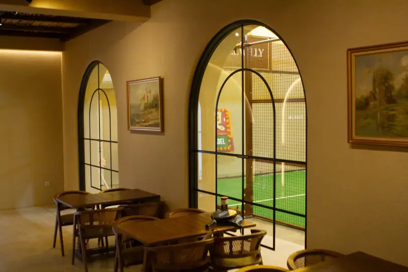 Arched windows from the lounge looking onto the court